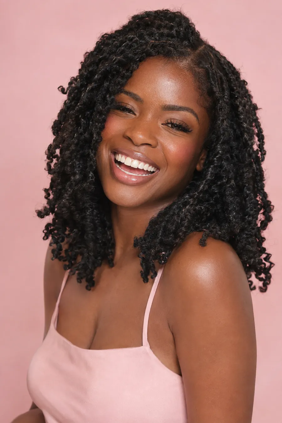 Laughing woman with shoulder-length bohemian passion twists